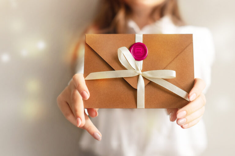 invitation card or gift certificate in woman hands. focus on han